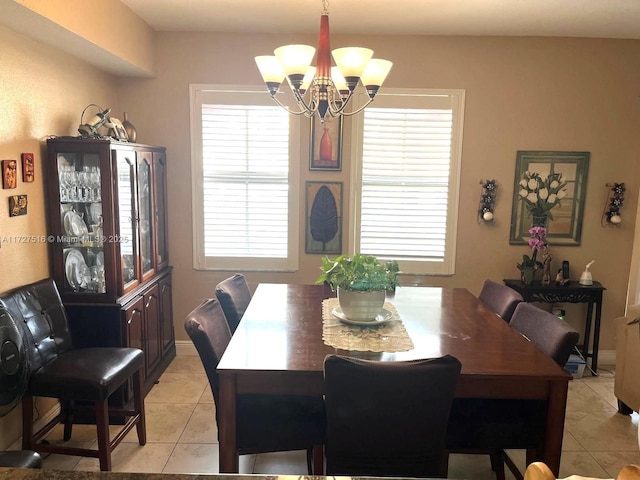 tiled dining space with an inviting chandelier