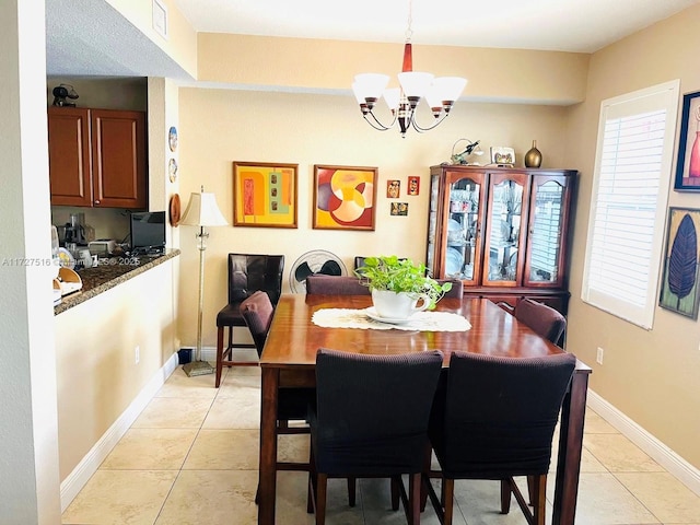 dining space featuring light tile patterned floors and a notable chandelier