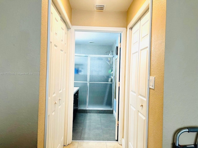 hall with light tile patterned floors