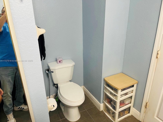 bathroom featuring toilet and tile patterned floors