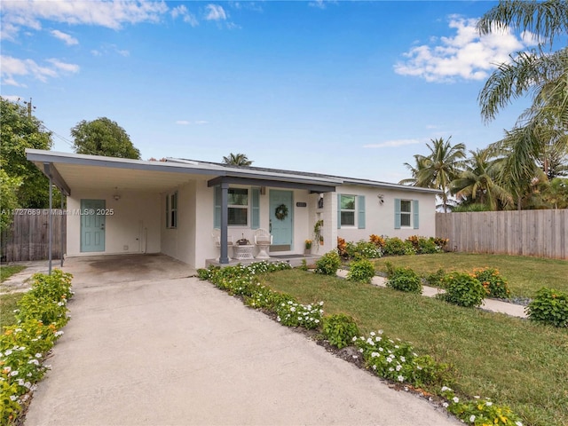 ranch-style home featuring a front lawn and a carport