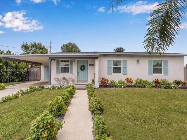 single story home featuring a carport, a porch, and a front yard