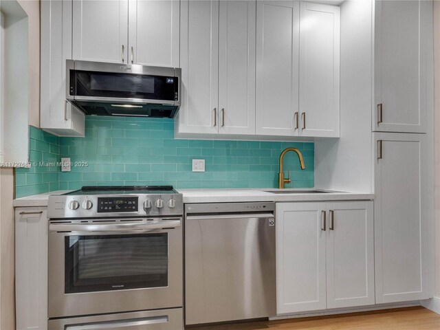 kitchen with stainless steel fridge with ice dispenser, light hardwood / wood-style flooring, white cabinets, and ceiling fan