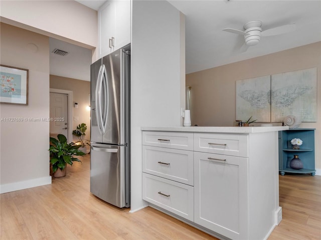 kitchen featuring white cabinetry, ceiling fan, stainless steel fridge with ice dispenser, and light wood-type flooring