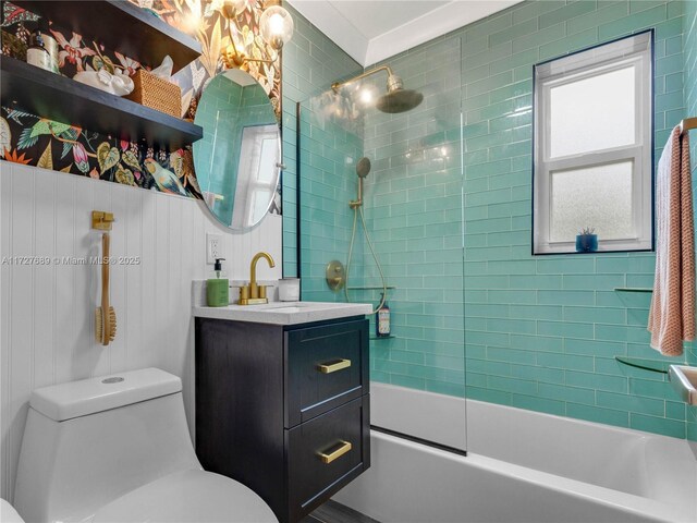 full bathroom with vanity, tiled shower / bath combo, and toilet