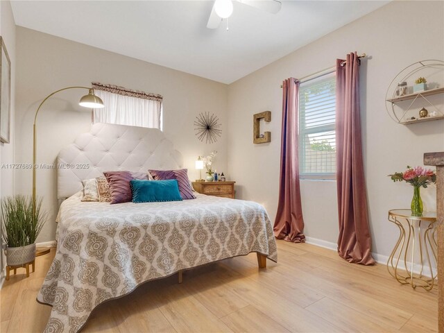 bedroom with light hardwood / wood-style flooring and ceiling fan