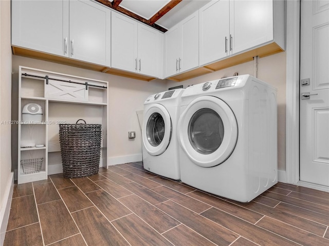 washroom featuring cabinets and washing machine and clothes dryer