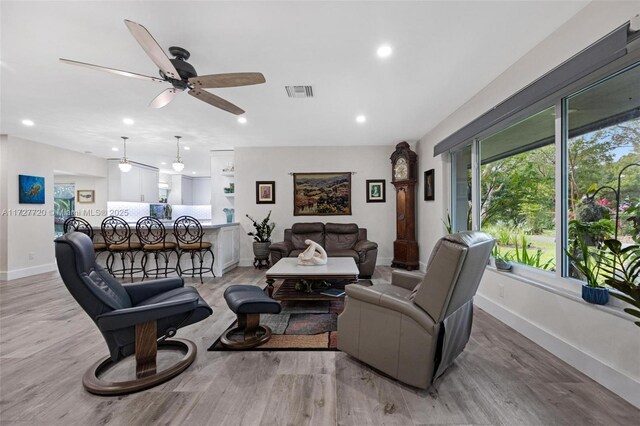 living room with hardwood / wood-style flooring and ceiling fan