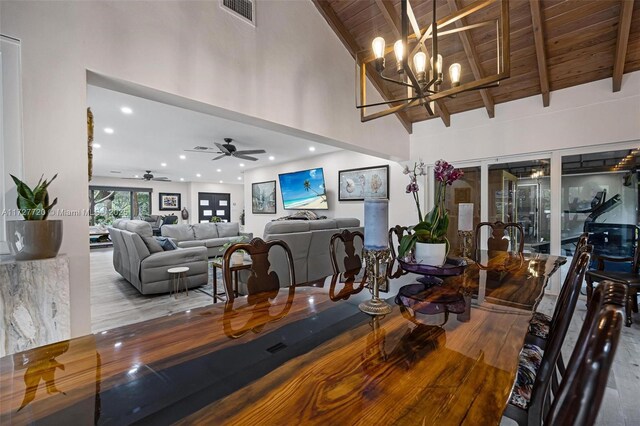 dining space with beamed ceiling, wooden ceiling, high vaulted ceiling, and light hardwood / wood-style flooring