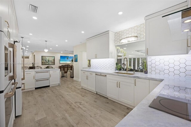 kitchen with white cabinetry and sink