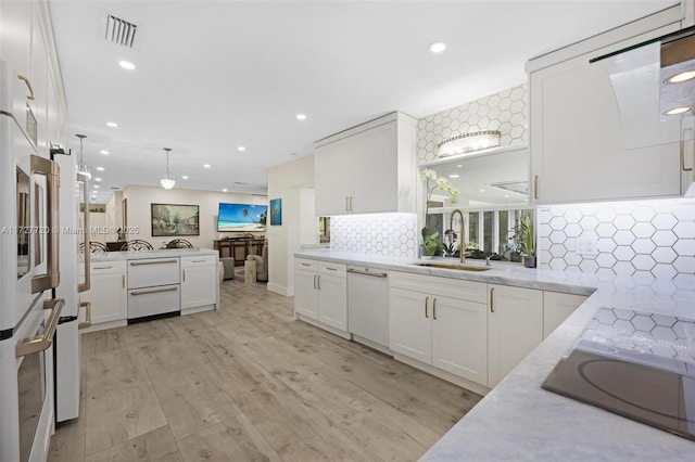 kitchen featuring white cabinetry and sink