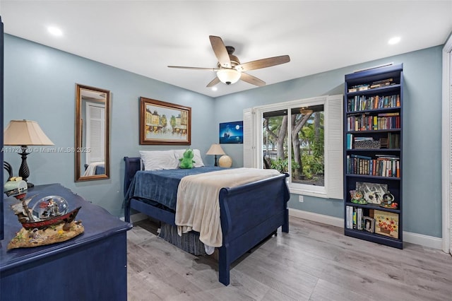 bedroom with ceiling fan and wood-type flooring