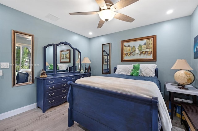 bedroom with ceiling fan and light wood-type flooring