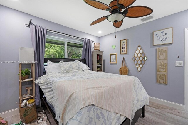 bedroom with light hardwood / wood-style floors and ceiling fan