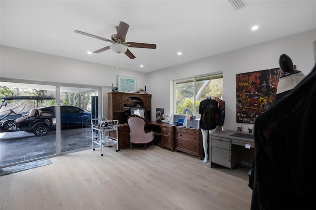 home office with ceiling fan and light hardwood / wood-style floors