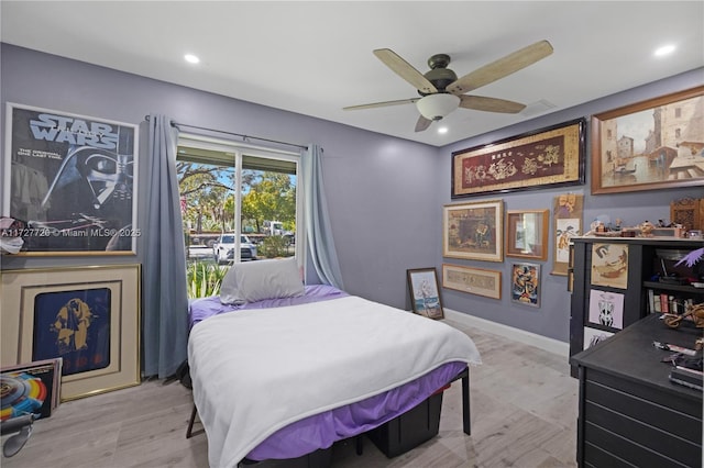 bedroom with ceiling fan and light hardwood / wood-style floors