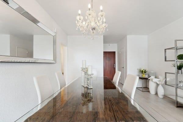 unfurnished dining area featuring hardwood / wood-style floors and a notable chandelier