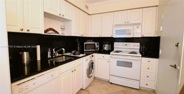 kitchen featuring washer / dryer, sink, light tile patterned floors, white appliances, and white cabinets