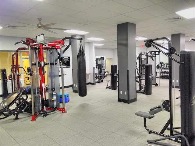 exercise room featuring ceiling fan and a drop ceiling