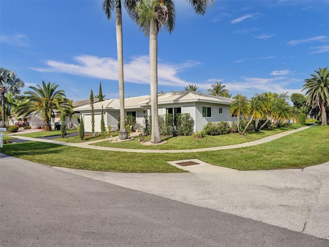 580 Eastwood Ln, Weston, FL 33326 - single story home with stucco siding, an attached garage, and a front lawn