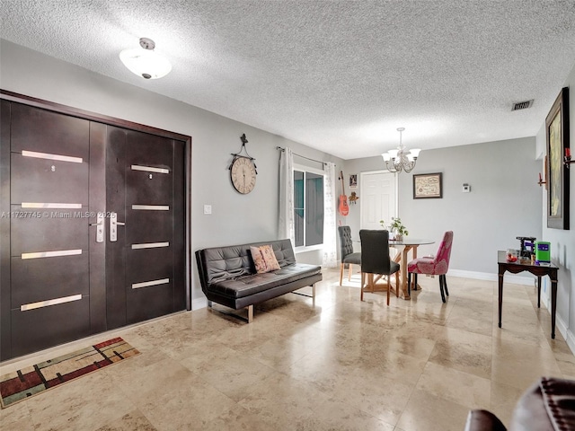 580 Eastwood Ln, Weston, FL 33326 - entryway featuring baseboards, a notable chandelier, a textured ceiling, and visible vents