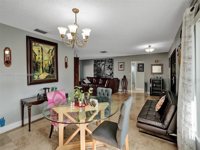 580 Eastwood Ln, Weston, FL 33326 - dining space with baseboards, a notable chandelier, a textured ceiling, and visible vents