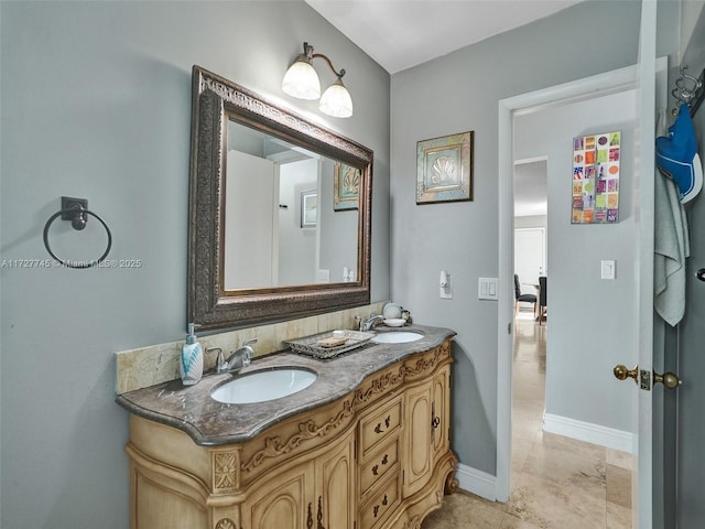 580 Eastwood Ln, Weston, FL 33326 - bathroom featuring baseboards, a sink, and double vanity