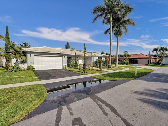 580 Eastwood Ln, Weston, FL 33326 - single story home featuring a tile roof, driveway, a garage, a front yard, and stucco siding