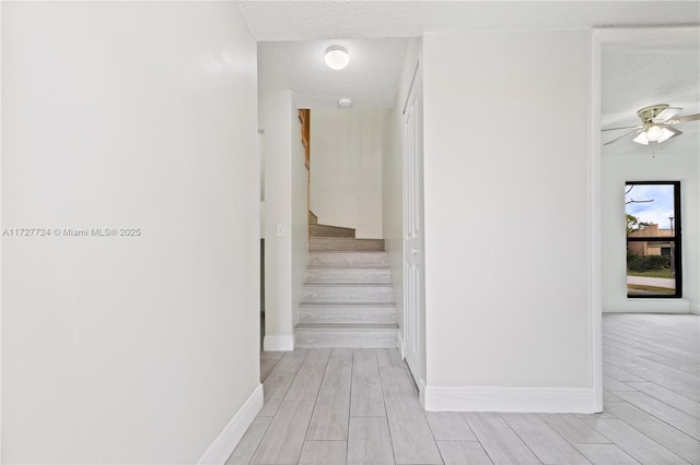 hall with a textured ceiling