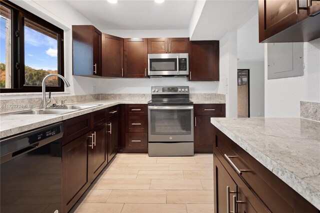 kitchen featuring dark brown cabinets, sink, and stainless steel appliances