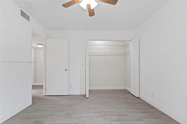 unfurnished bedroom with ceiling fan, a closet, and light hardwood / wood-style flooring