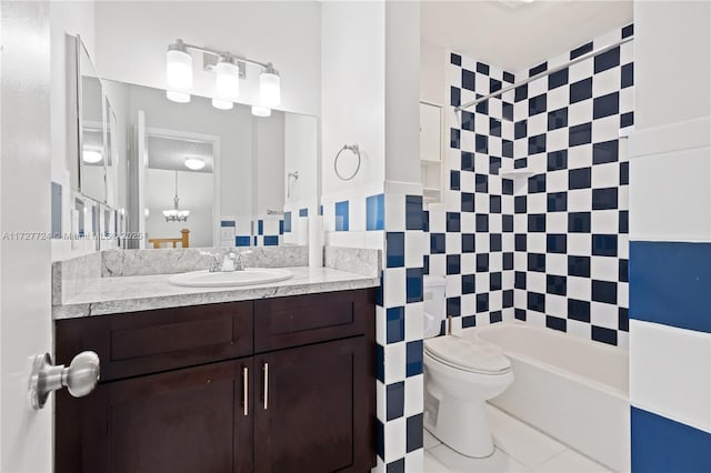 full bathroom featuring tiled shower / bath combo, tile patterned flooring, vanity, tile walls, and toilet