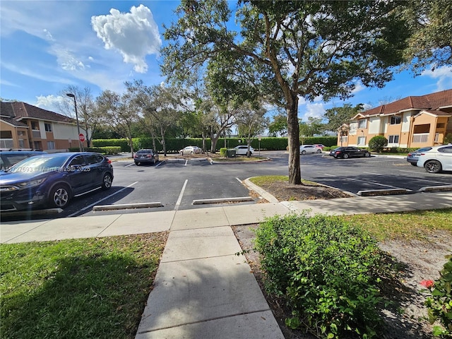 view of road featuring a residential view, curbs, sidewalks, and street lights