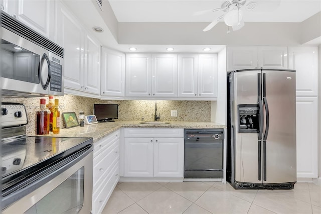 kitchen featuring tasteful backsplash, sink, white cabinets, and appliances with stainless steel finishes