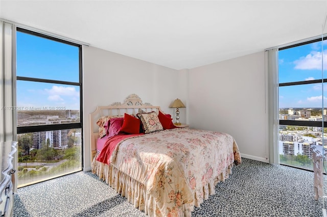 bedroom featuring expansive windows and multiple windows