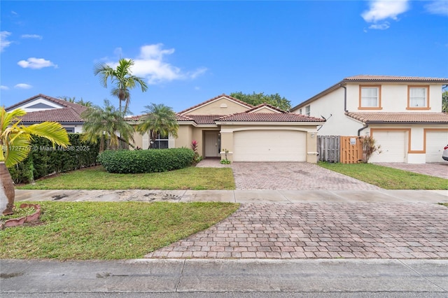 mediterranean / spanish house with a garage and a front yard