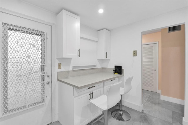 kitchen featuring white cabinets