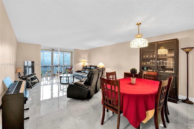 dining room featuring floor to ceiling windows and a textured ceiling