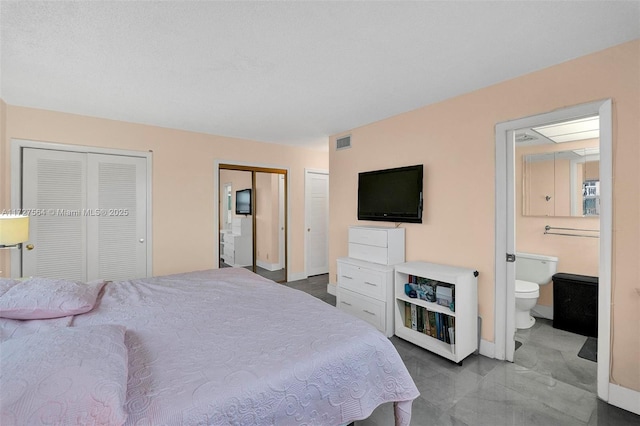 bedroom with ensuite bath and two closets