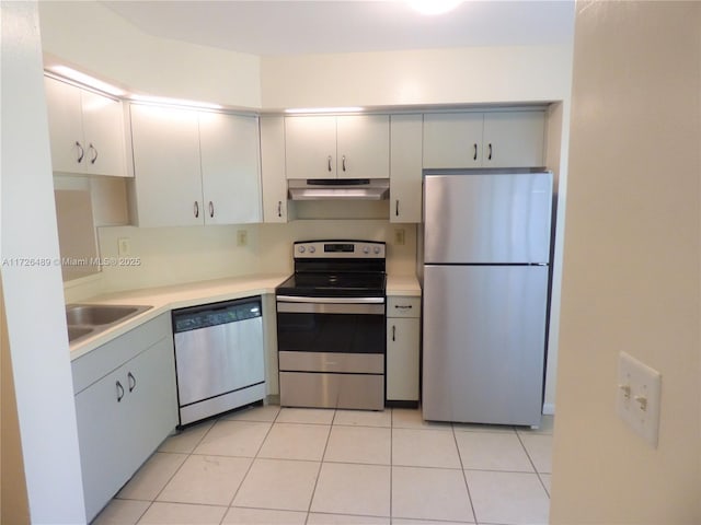 kitchen featuring light tile patterned floors, stainless steel appliances, and sink