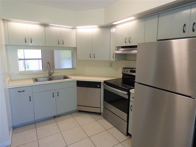 kitchen featuring appliances with stainless steel finishes, sink, and light tile patterned flooring