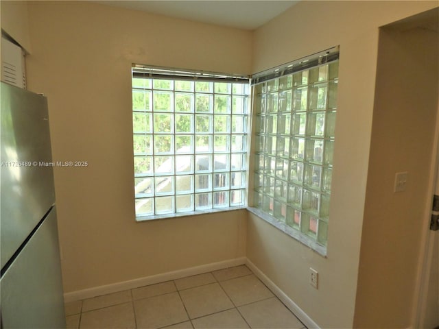 spare room with light tile patterned floors