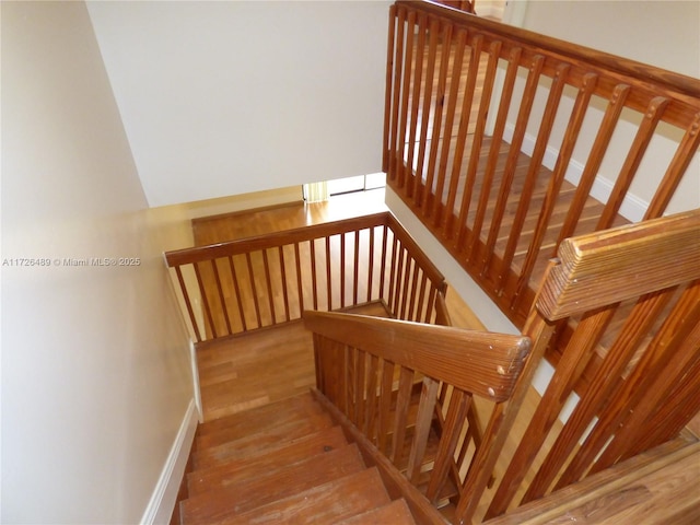 stairs with hardwood / wood-style floors