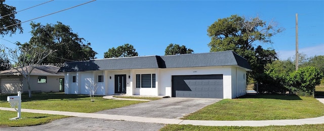 ranch-style home featuring a garage and a front yard