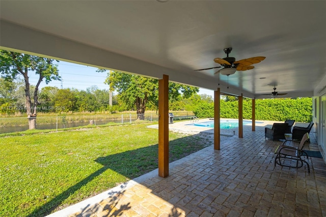 view of patio / terrace with ceiling fan and a fenced in pool