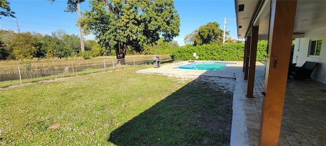 view of yard with a patio area and a fenced in pool