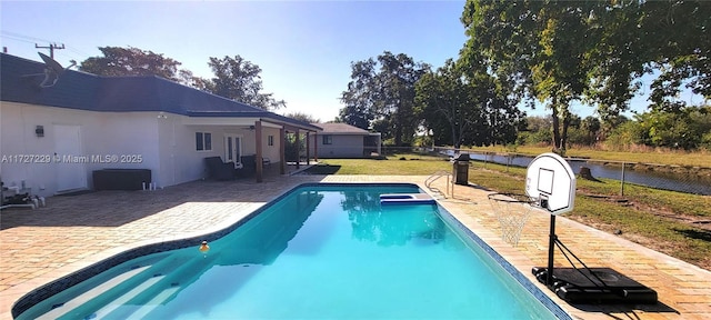 view of swimming pool with a lawn and a patio area