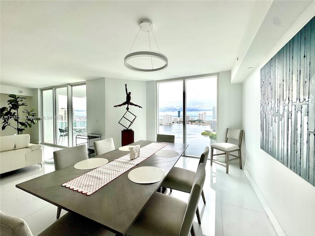 tiled dining room with a wall of windows