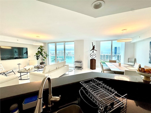 kitchen with floor to ceiling windows and hanging light fixtures