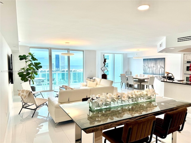 tiled dining space featuring expansive windows